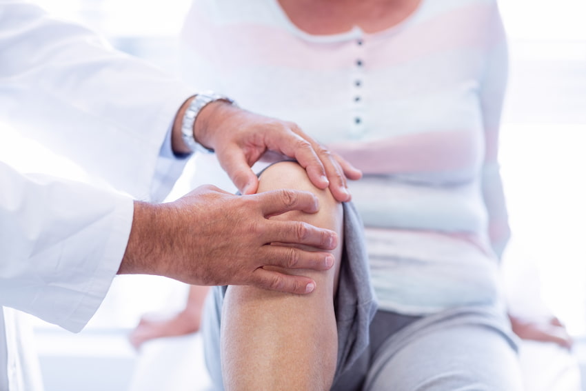Senior woman suffering from knee osteoarthritis