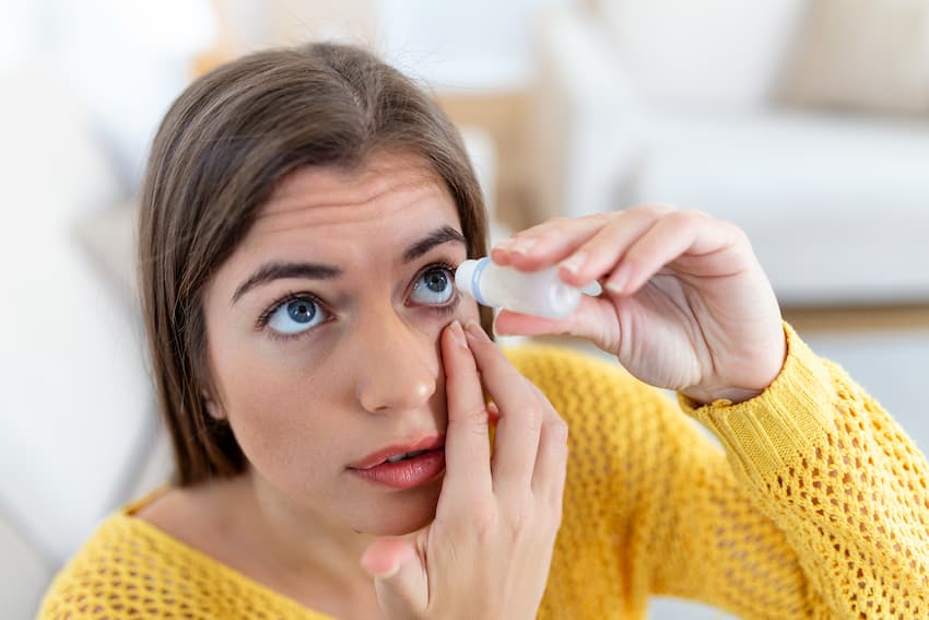 Woman dropping Restasis to treat dry eye